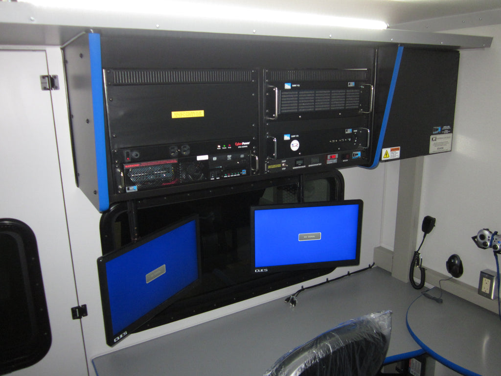 CUES inspection truck control room with monitors, desk and equipment rack
