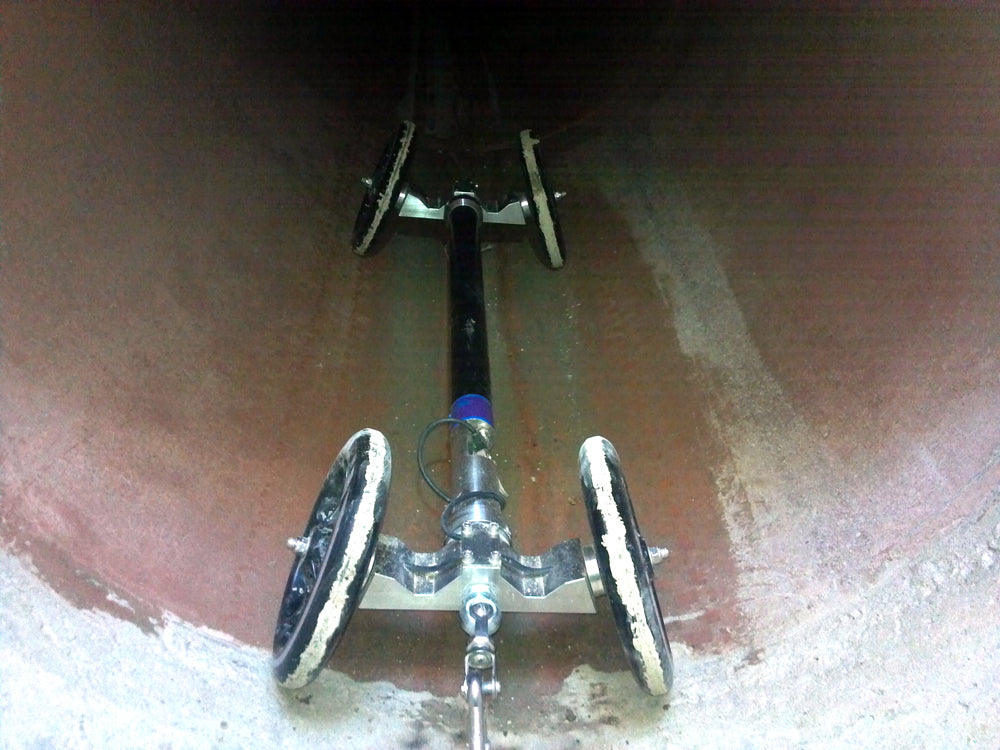 CUES AMP probe on wheel sets inside a large pipe