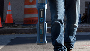 CUES Accupoint MS611 locator carried past traffic cones on a street