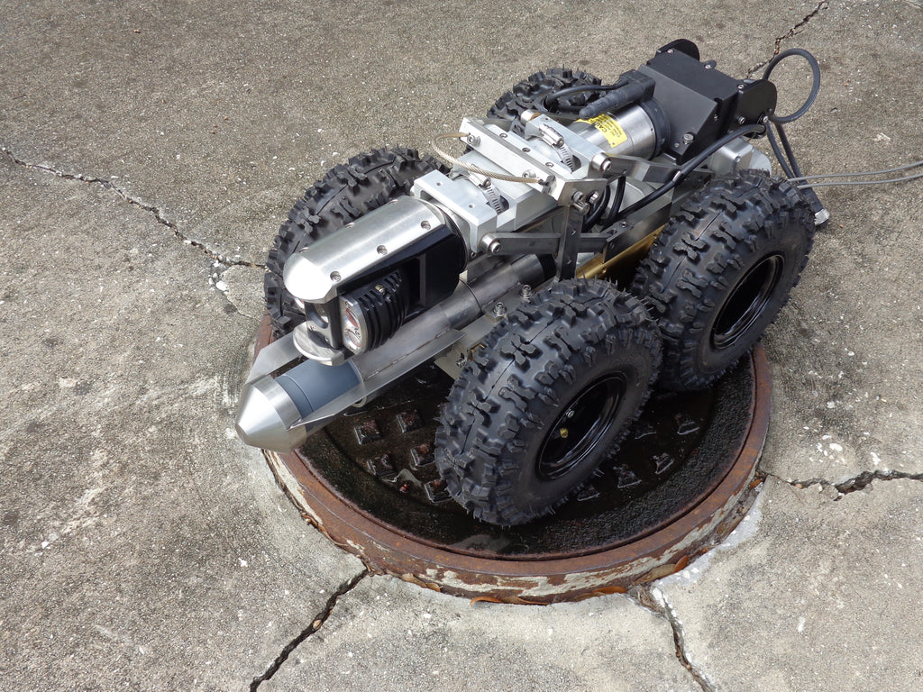CUES CATVS stainless transporter with camera and sonar on a manhole cover