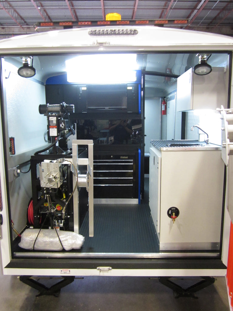 CUES trailer-mounted inspection system rear equipment room with reel unit, winch lift and workbench