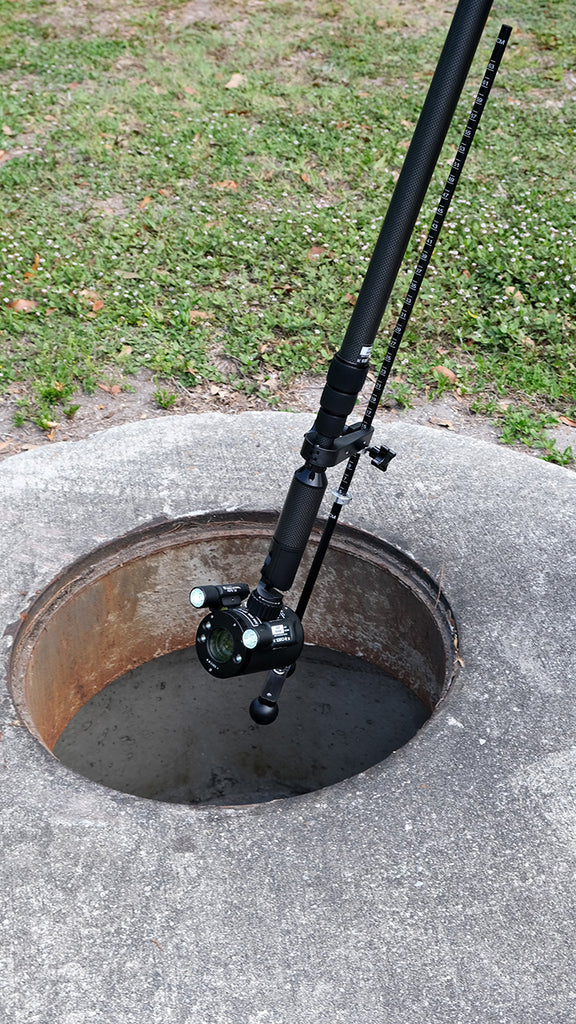 CUESrecon pole camera lowered on its pole into a manhole opening