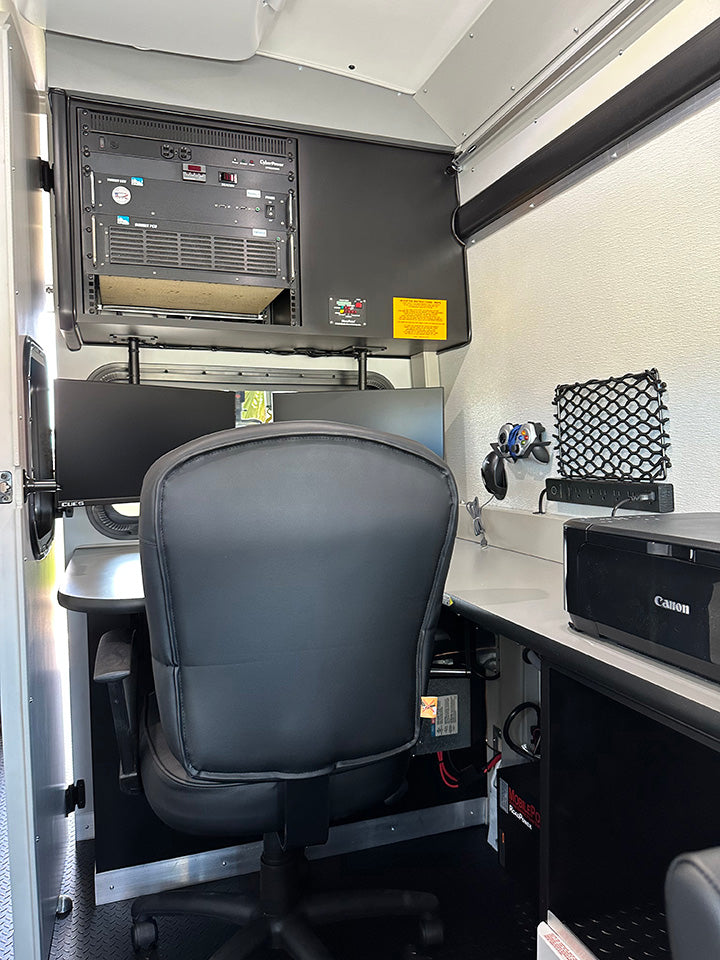 CUES inspection van control room with operator chair, monitors and equipment rack