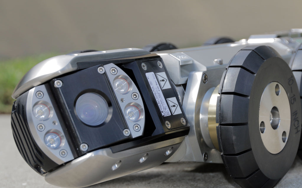 CUES sewer inspection camera head on a wheeled crawler, close-up